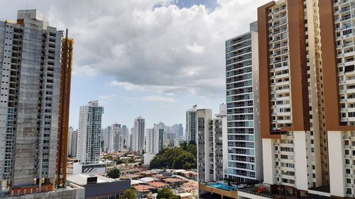 Modern buildings in city against sky