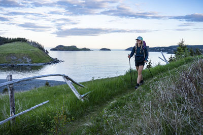 Female hiking mickeleens path on east coast trail witless bay