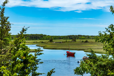 Scenic view of sailboat in lake against sky