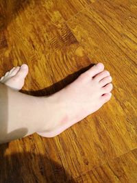 High angle view of woman lying on hardwood floor