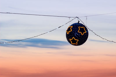 Low angle view of spider on web against sky during sunset