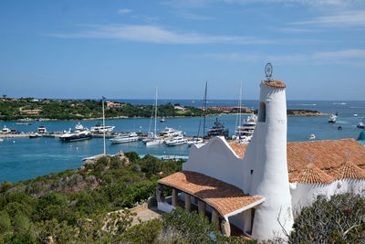 Sailboats moored on sea against sky