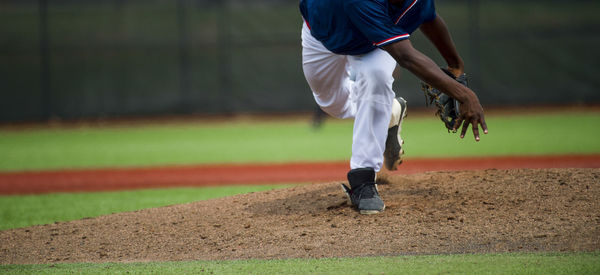 Low section of baseball player standing on playing field