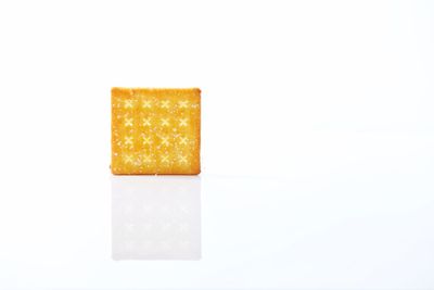 Close-up of yellow over white background