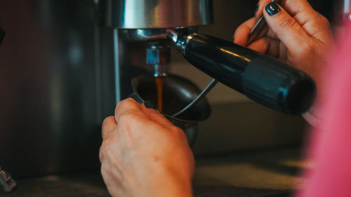 Midsection of man holding coffee cup