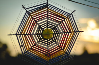 Directly below shot of glass building against sky during sunset