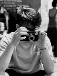 Portrait of woman photographing outdoors