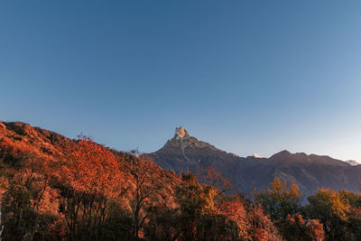 Scenic view of mountains against clear blue sky