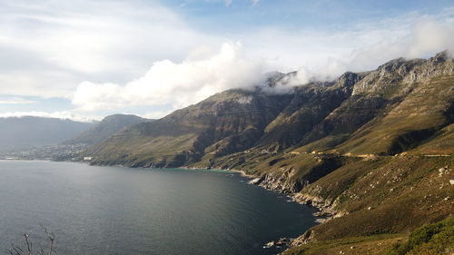 Scenic view of lake by mountains against sky