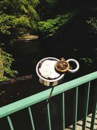 High angle view of drink on railing