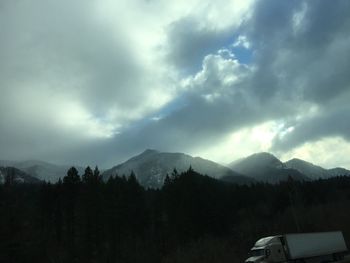 Scenic view of mountains against cloudy sky