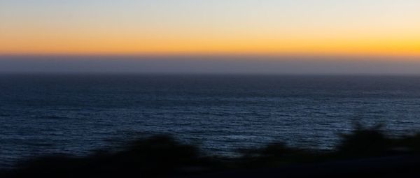 Scenic view of sea against clear sky during sunset