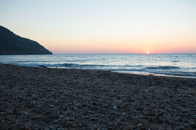 Scenic view of sea against clear sky during sunset