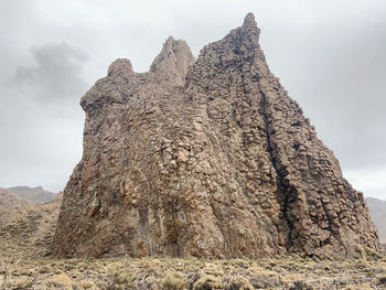 Low angle view of rock formations against sky