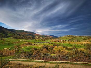 Scenic view of agricultural field against sky