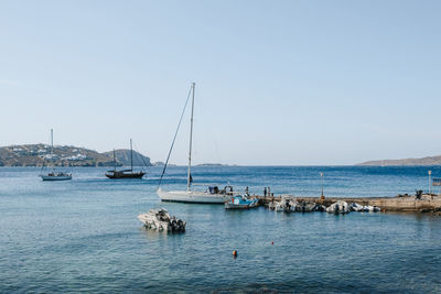 Yachts and boats moored by a pier in agios ioannis, a small town in mykonos, greece.