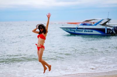 Side view of a girl standing on beach