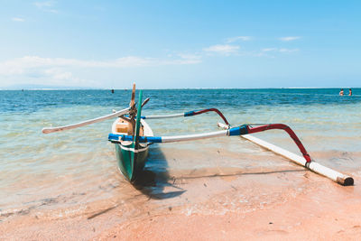 Boat on beach against sky