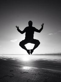 Woman jumping on beach