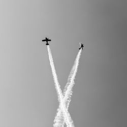 Low angle view of airplane flying against sky