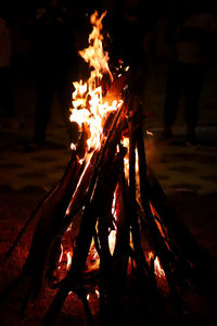 Bonfire on wooden log at night