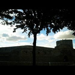 Low angle view of building against cloudy sky
