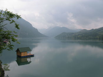 Scenic view of lake and mountains against sky