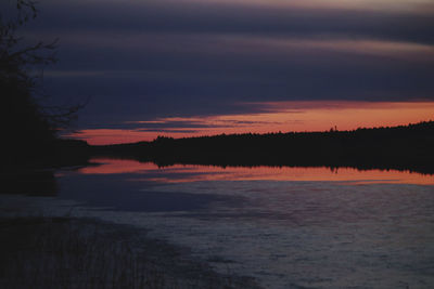 Scenic view of lake against romantic sky at sunset