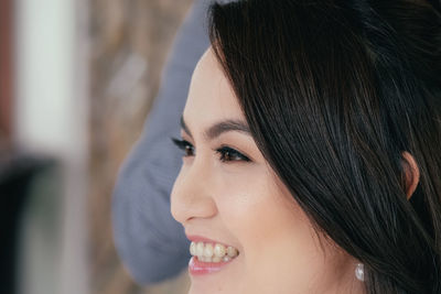 Close-up of happy woman looking away