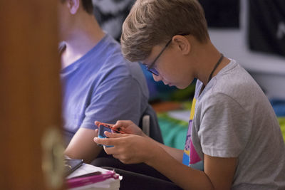 Side view of boy playing video game