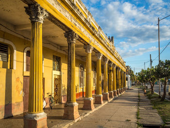Colonnades on old building by footpath