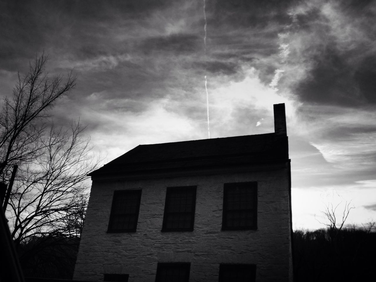 architecture, built structure, building exterior, sky, low angle view, cloud - sky, cloudy, cloud, house, tree, bare tree, window, residential structure, building, overcast, residential building, weather, outdoors, silhouette, no people