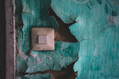 Close-up of doorbell at abandoned building 