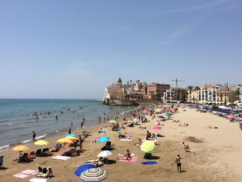 People on beach against sky