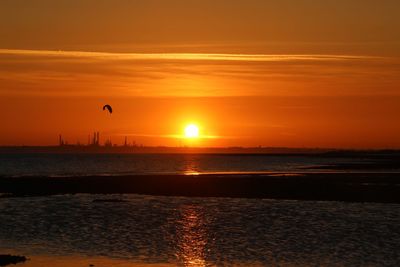 Scenic view of sea against orange sky