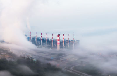 Buildings in city amidst fog