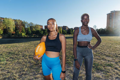 Confident young american football players on field