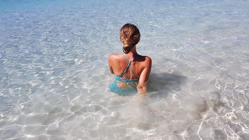 Rear view of woman in bikini at beach