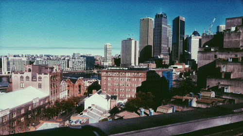 Modern buildings in city against clear sky