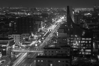 High angle view of city lit up at night