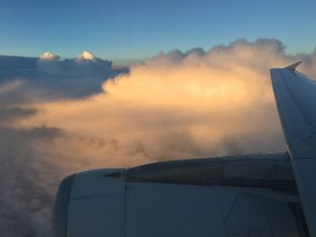 Aerial view of cloudscape seen through airplane window