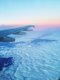 Cropped image of airplane flying over sea