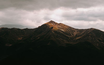 Scenic view of mountain against cloudy sky