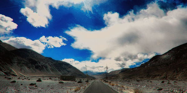 Panoramic view of road amidst mountains against sky