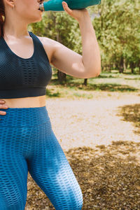 Rear view of woman exercising in park