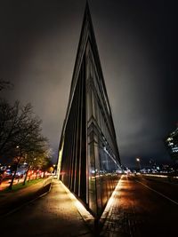 Illuminated bridge against sky at night