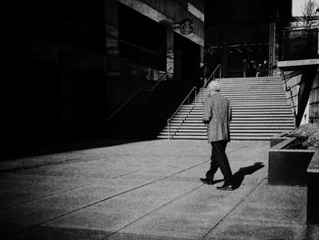 People walking on footpath in city