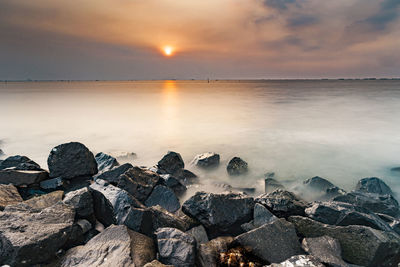 Scenic view of sea against sky during sunset