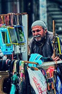 Portrait of man standing at market stall