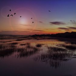 Scenic view of lake against sky during sunset